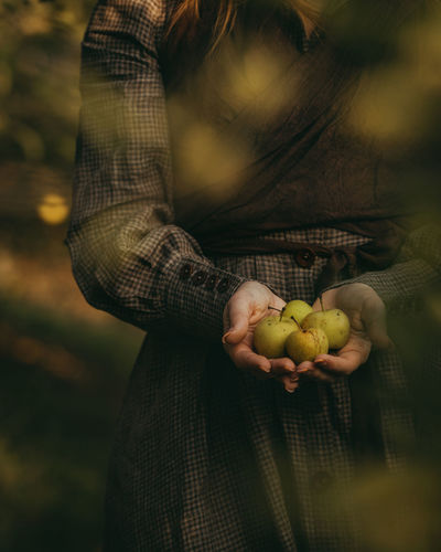 Woman holding green apples