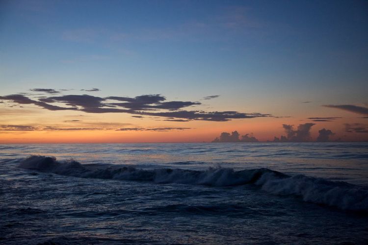 Scenic view of sea against sky at sunset