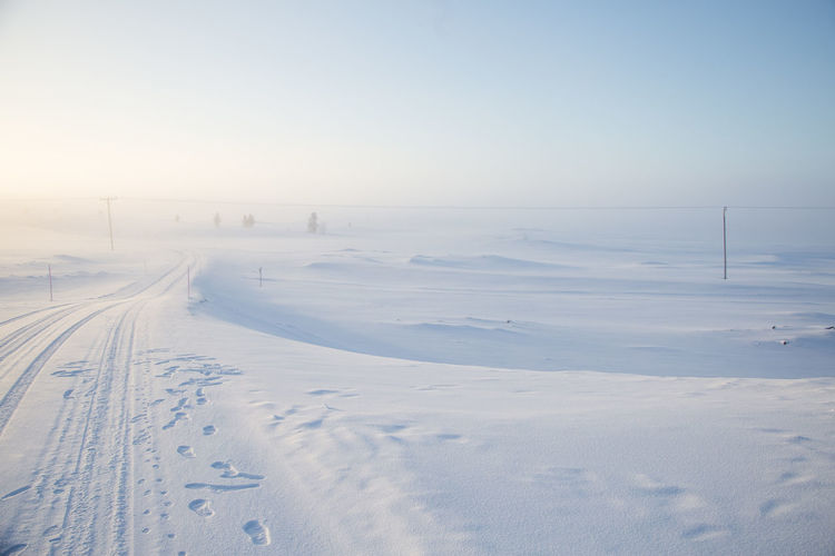 A beautiful, misty morning in the norwegian hills in winter. white, hazy landscape. 