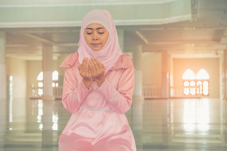 Woman praying at mosque