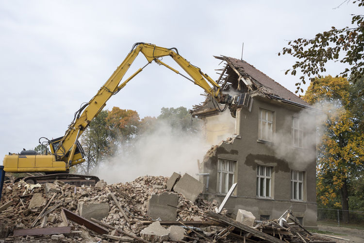 Machinery demolishing building