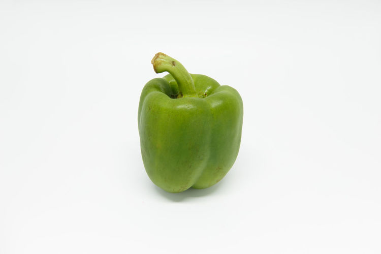 Close-up of green bell pepper against white background