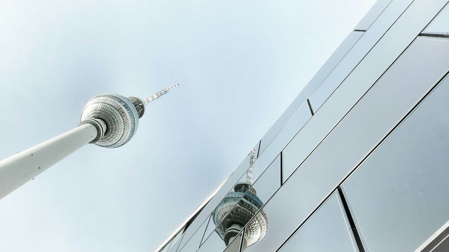 Low angle view of communications tower against sky