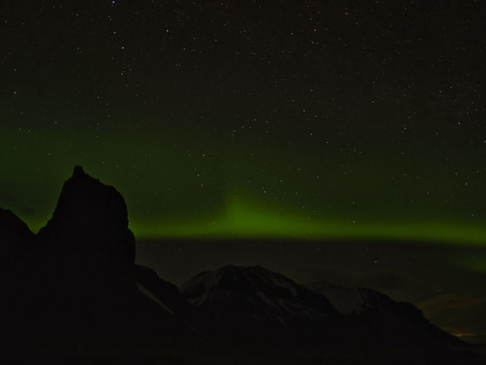 Low angle view of silhouette rock against sky at night