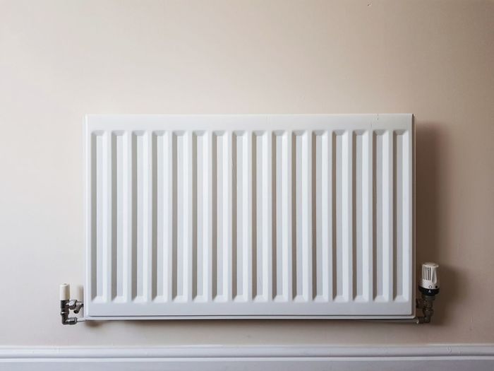 Radiator on white wall at home