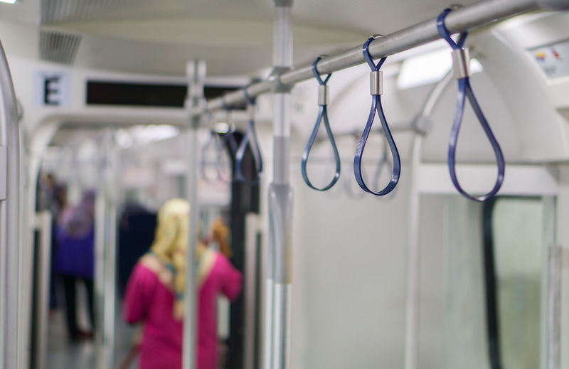 Close-up of handles on rack in metro train