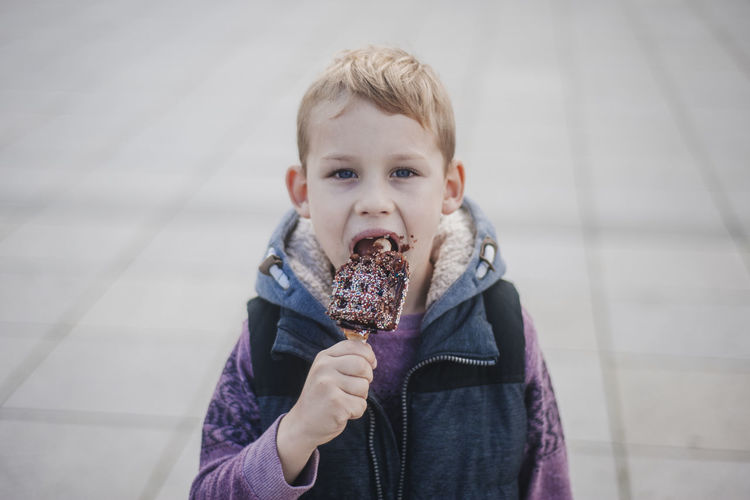 Portrait of cute boy eating waffle