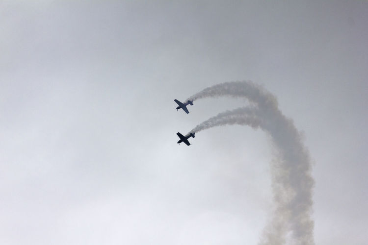 Low angle view of airshow in sky