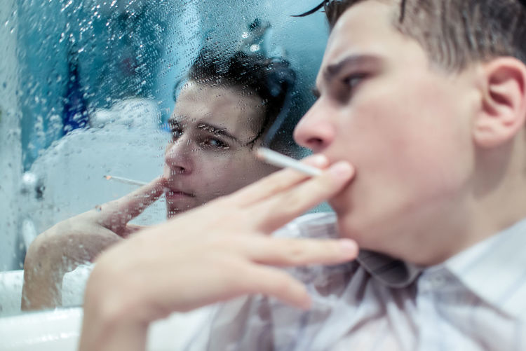 Close-up of men with cigarette