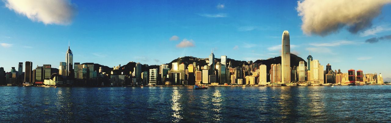 Panoramic shot of city skyline against sky at victoria harbour