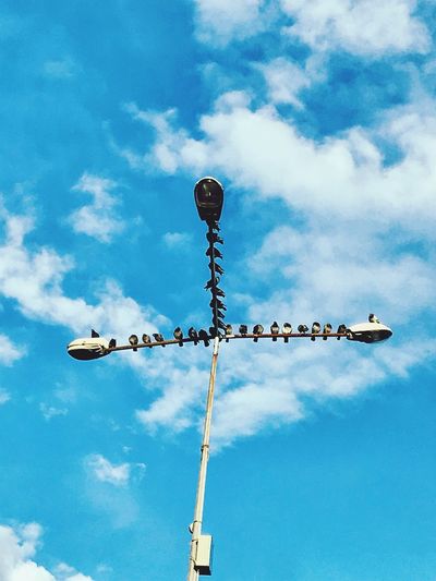 Low angle view of windmill against sky