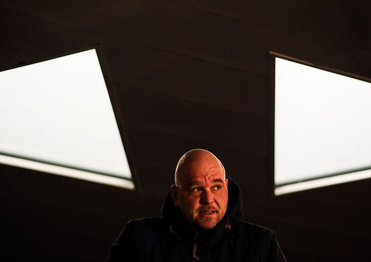 Man against illuminated ceiling