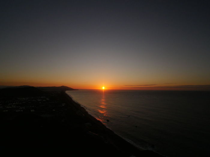 Scenic view of sea against clear sky during sunset