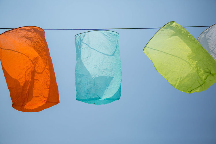 Low angle view of paper lantern hanging against clear sky