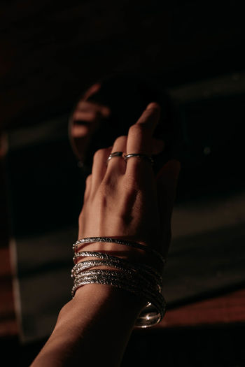 Cropped hand of woman wearing bangles