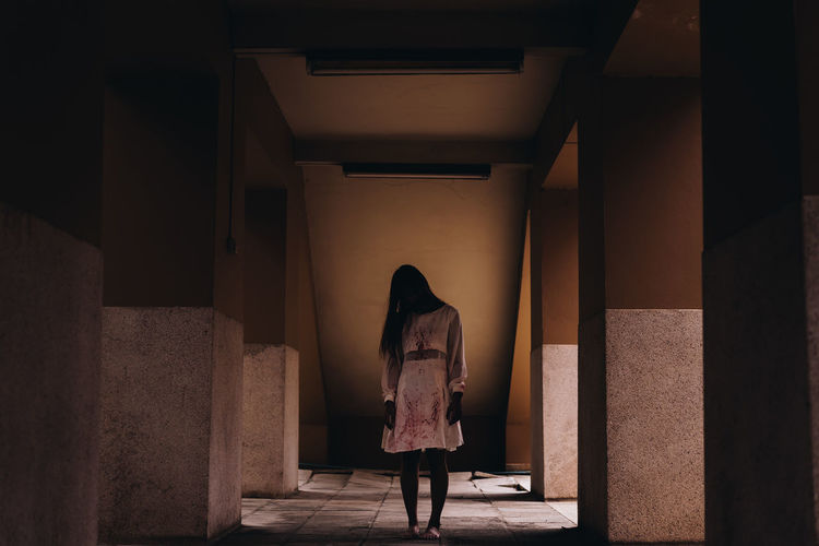 Full length of zombie standing in corridor