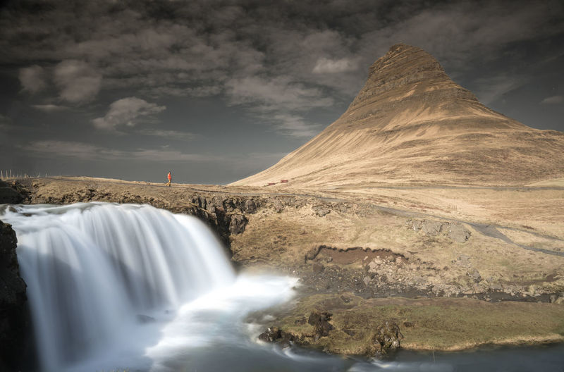 Scenic view of waterfall against sky