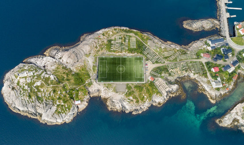 Aerial view of soccer field amidst sea