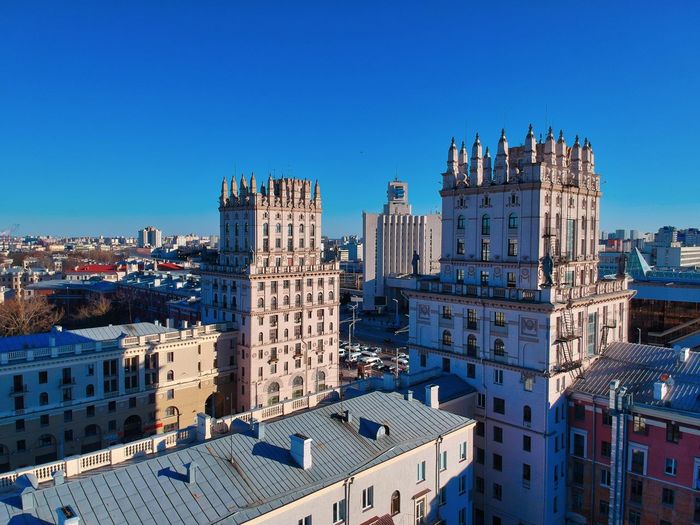 Buildings in city against blue sky