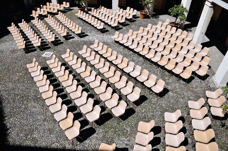 High angle view of empty chairs arranged in courtyard
