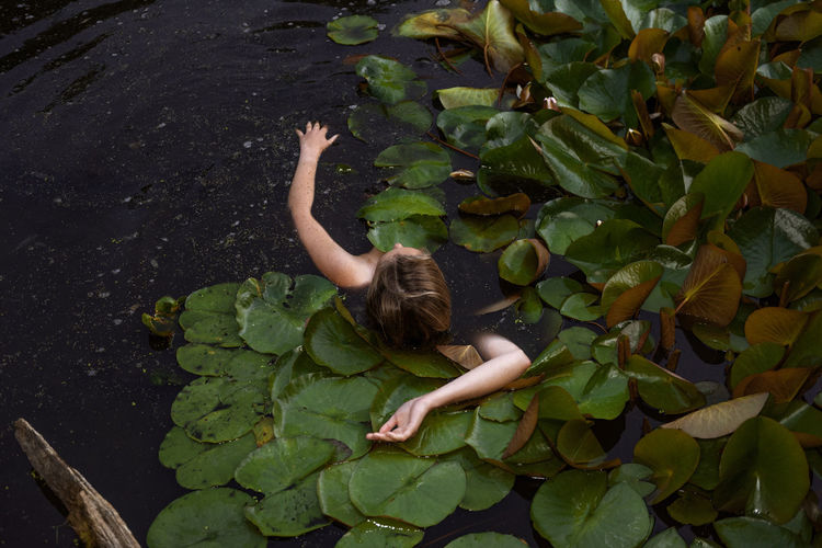 High angle view of young woman in pond
