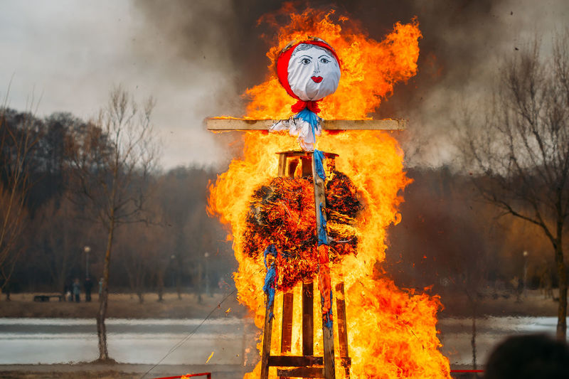 Low angle view of burning statue against sky