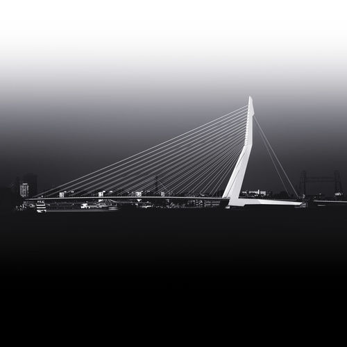 Illuminated bridge over river against sky at night