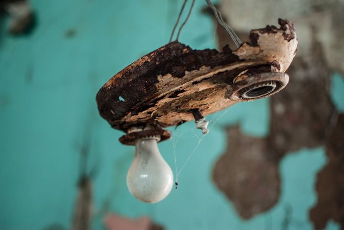 Close-up of old light bulb in abandoned house
