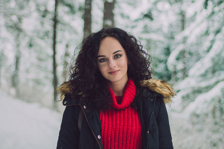 Portrait of young woman with curly hair during winter