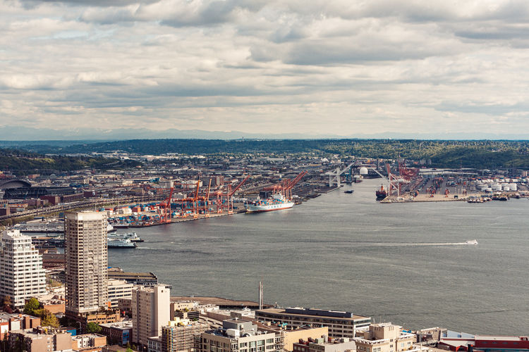 High angle view of buildings by sea against sky