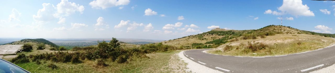 Panoramic view of road amidst mountains against sky