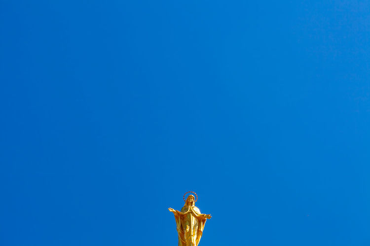 Golden madonna sculpture on top of santa maria degli angeli basilica, assisi, italy