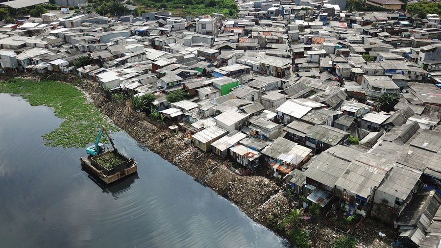 High angle view of river amidst houses in city
