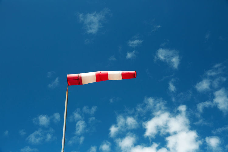 Low angle view of windsock against sky