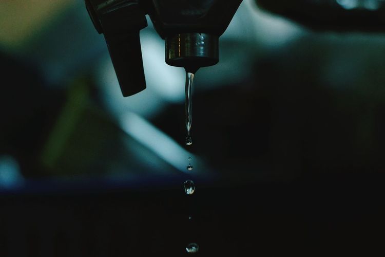 Close-up of dripping tap