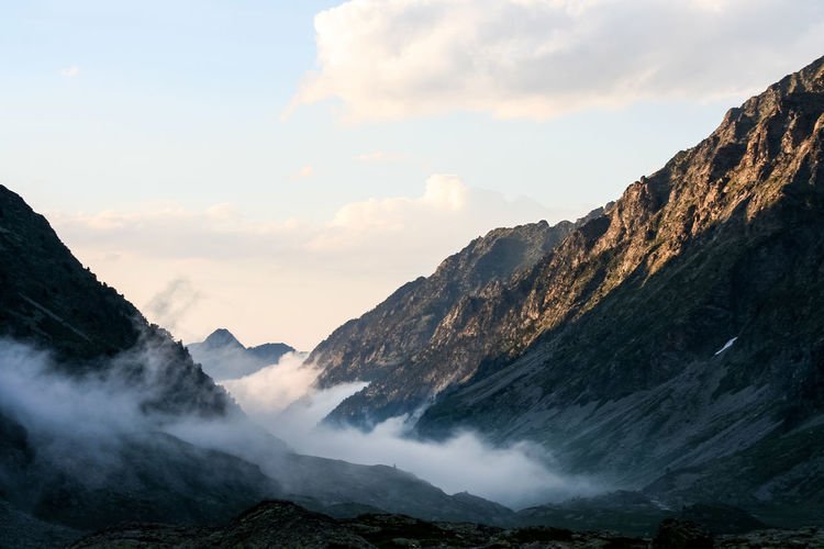 Scenic view of pyrenees against sky during foggy weather