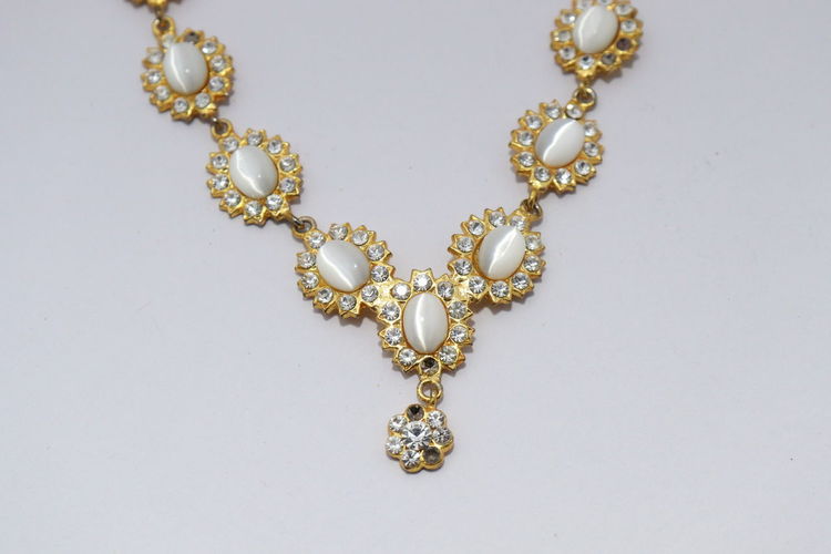 Close-up of decoration traditional indian wedding jewellery necklace with white diamond.