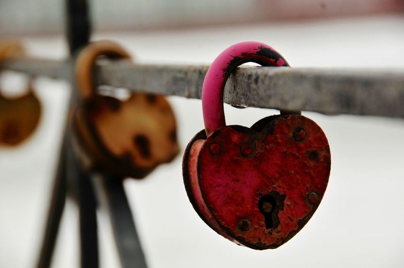 Close-up of heart shaped padlock on railing