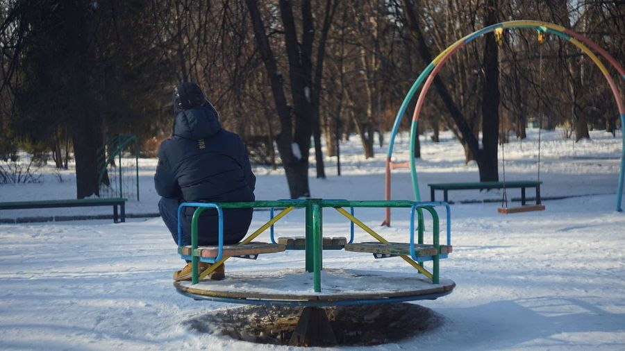 Boy on playground at park during winter