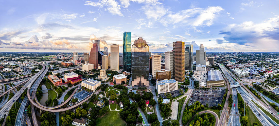 High angle view of houston skyline with park in foreground against cloudy sky