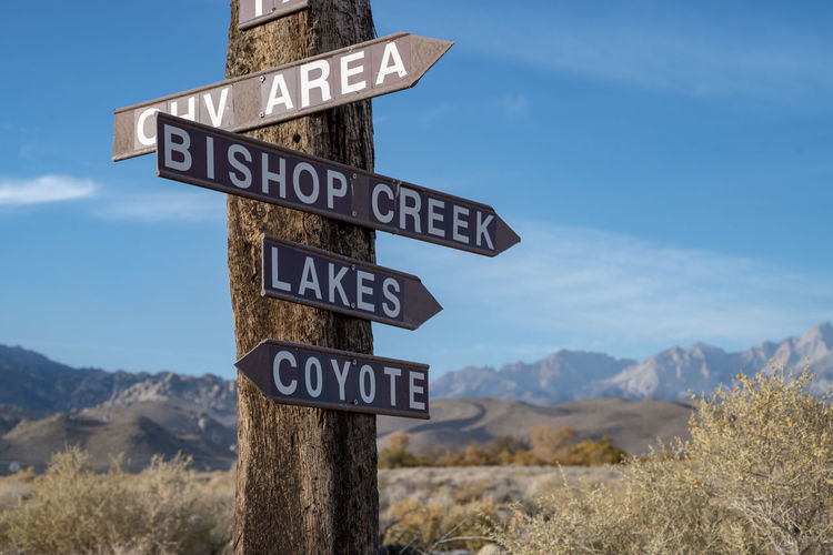 Wood sign post and directional arrows in rural america desert mountains 