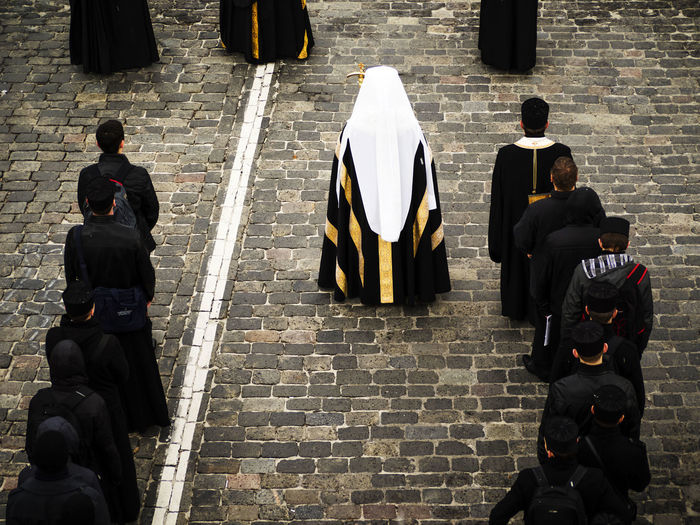 High angle view of priests standing on footpath at church