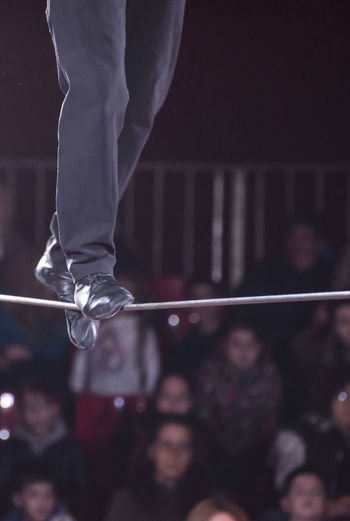 Low section of performer walking on tightrope during event