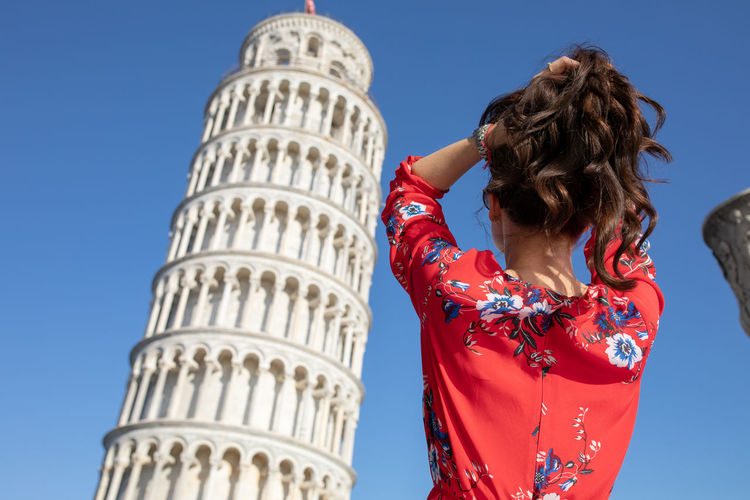 Woman standing against leaning tower of pisa