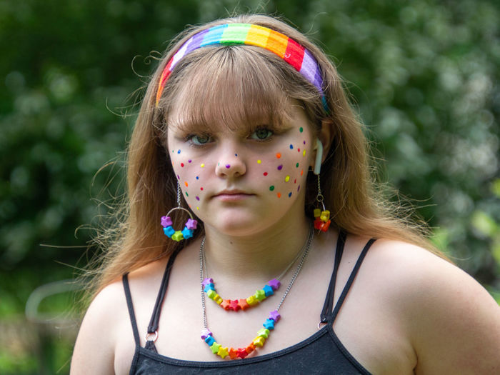 Close-up portrait of girl with face paint standing outdoors