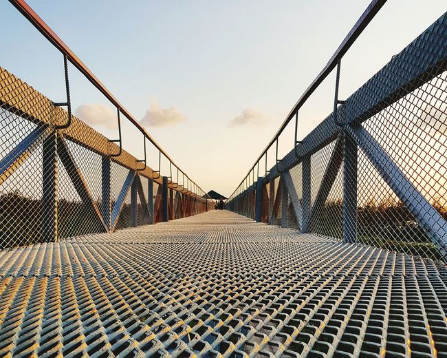 Close-up of footbridge against sky