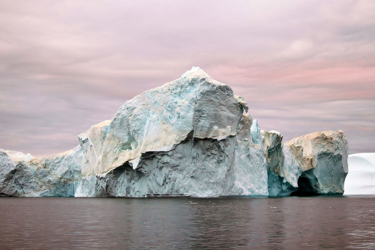 Scenic view of sea, iceberg and sky