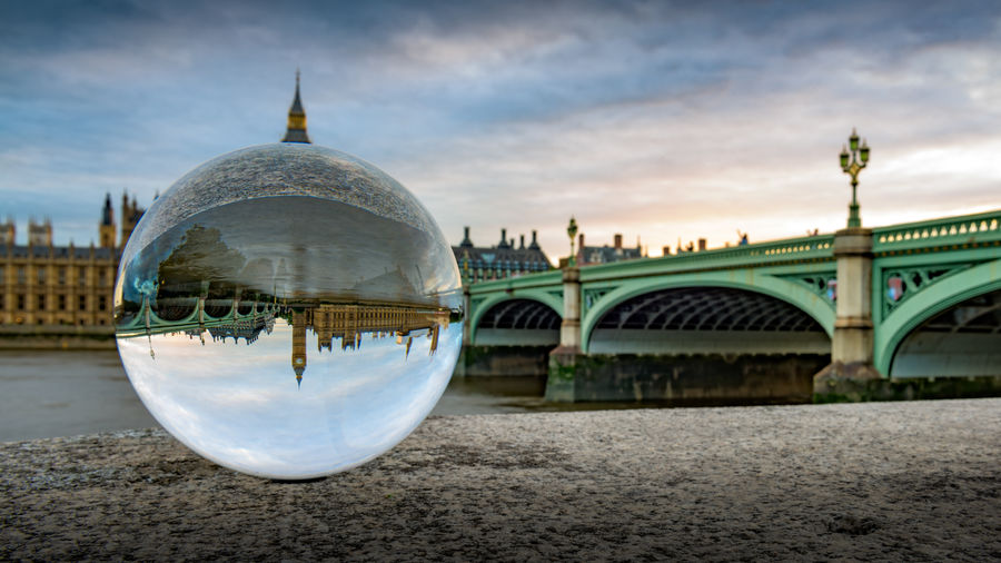 Reflection of big ben and westminster bridge on crystal ball