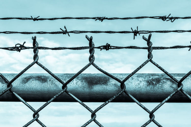 Full frame shot of chainlink fence against sky