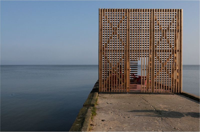 Wooden structure on pier over sea against sky